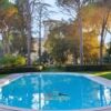 Historic luxury villa in Umbria featuring a swimming pool and lush gardens.