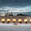 Ancient stone farmhouse with arches in Ceglie Messapica, Italy, under a dramatic evening sky.