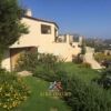 Sea-view villa in Palau with lush gardens and outdoor terraces.