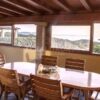 Elegant dining area with panoramic sea views in a Sardinian luxury villa.