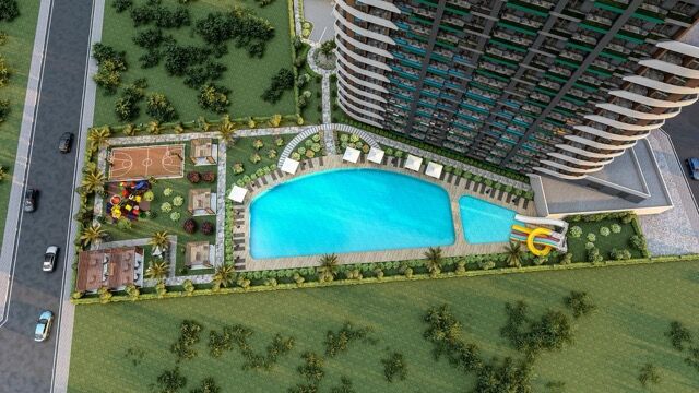Aerial view of stylish apartments near the beach in Mersin with pool and garden amenities.