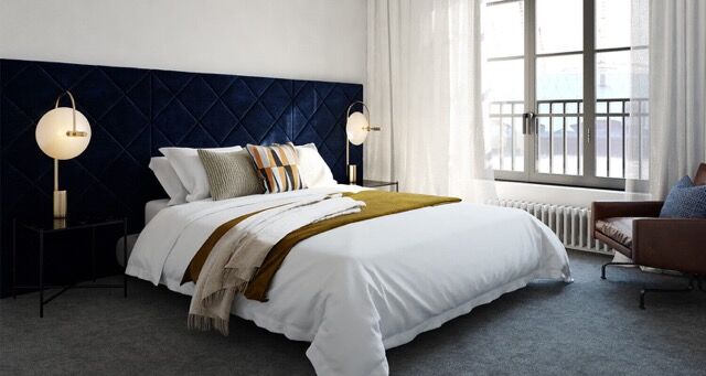 Elegant bedroom overlooking the river with stylish furnishings and natural light. Perfect for luxuri.
