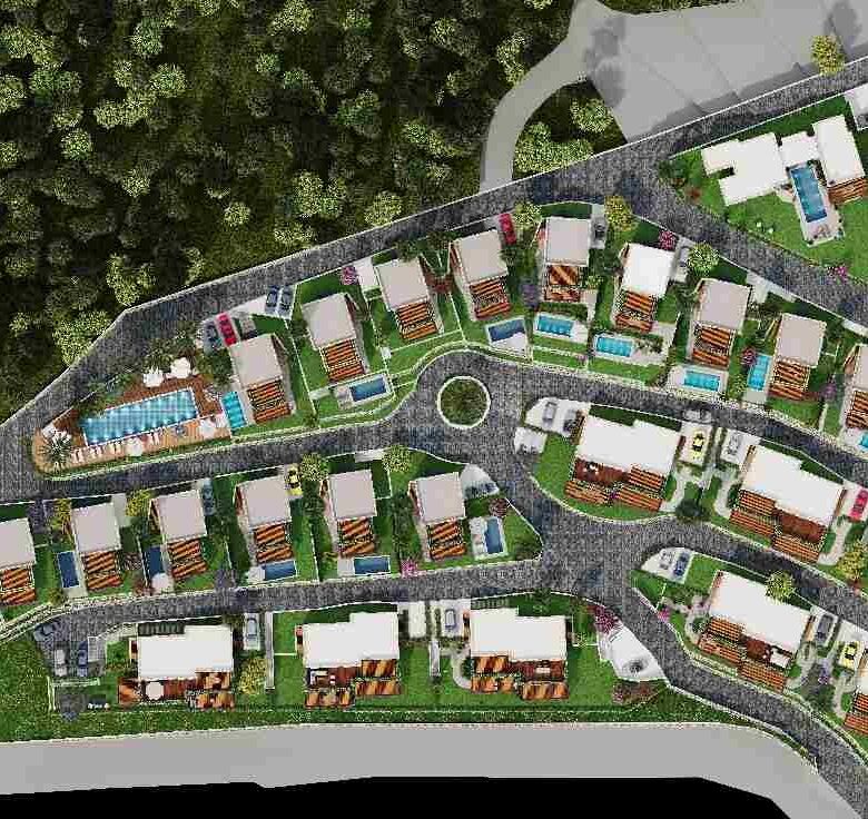 Aerial view of sea view properties in a gated complex with swimming pools in Bodrum.