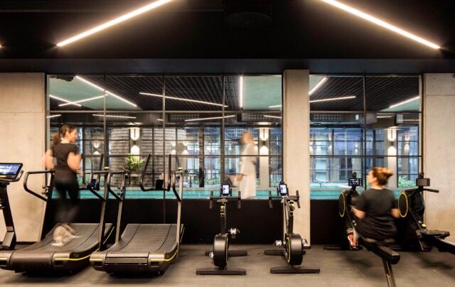 Modern gym at Riverside Residences, London with cardio equipment and scenic views.