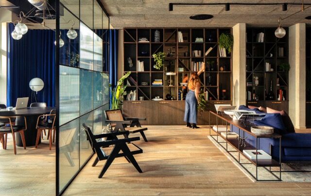 Elegant interior of a riverside home featuring contemporary furniture and large windows showcasing s.