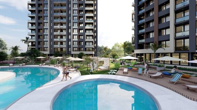 Modern luxury apartments with swimming pool and outdoor lounging areas in Mersin.