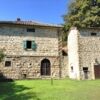 Historic stone estate with multiple houses for sale in Cortona, Tuscany, Italy.
