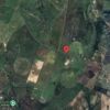 Aerial view of a plot of land for sale in Benavente, Portugal, surrounded by greenery and farmland.