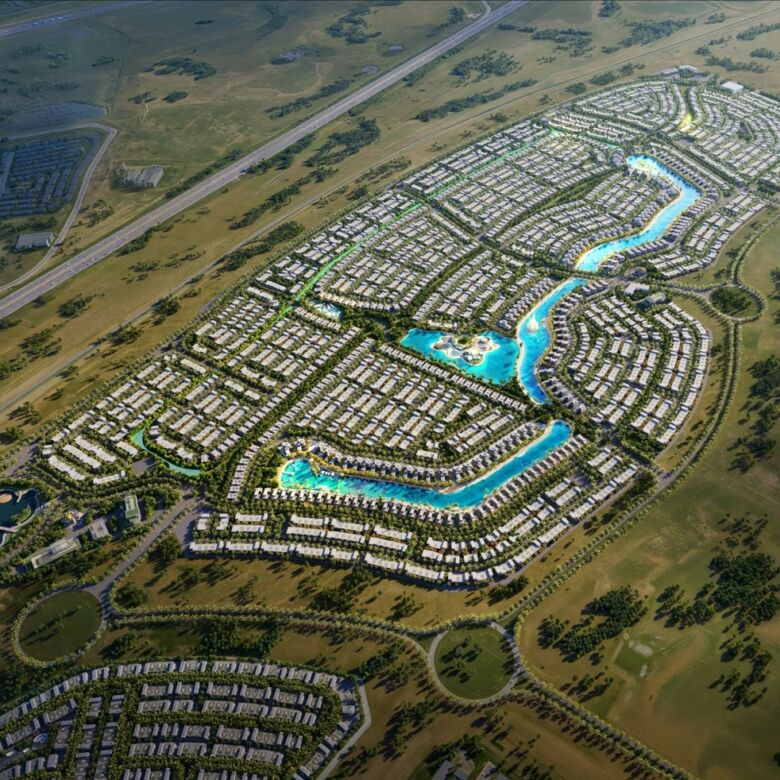 Aerial view of a luxury island community in Dubai with waterways and modern villas.