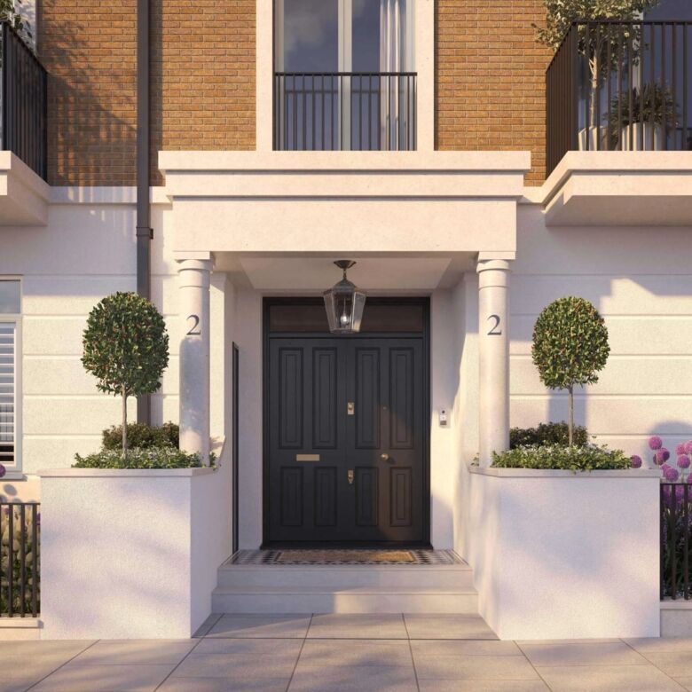 Elegant townhouse entrance with modern design and lush greenery.