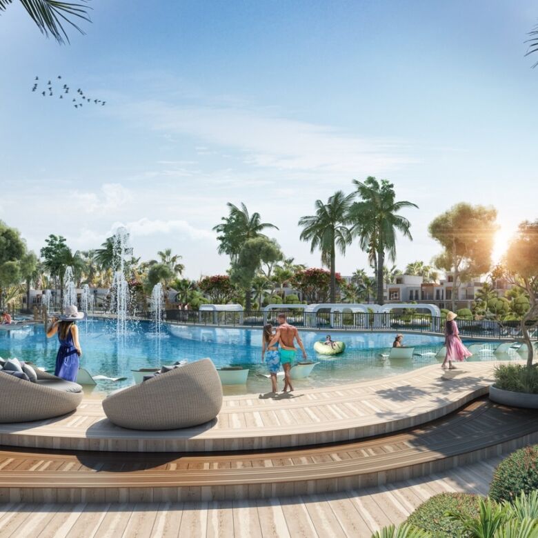 Lagoon-style pool with palm trees and relaxing seating areas in Dubai’s Mykonos-inspired community.