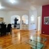 Spacious living room in a renovated barn with modern decor and wooden floors.