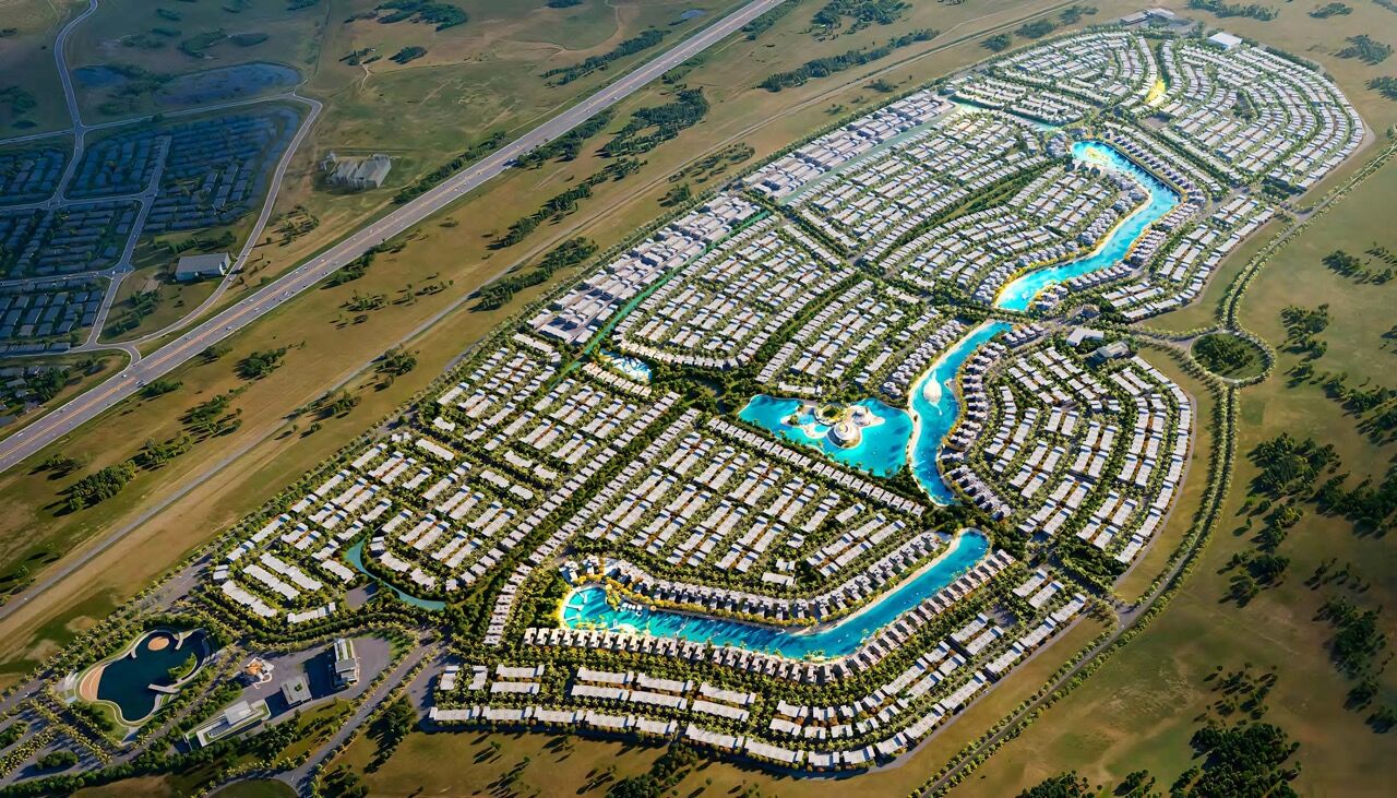Aerial view of a luxurious private island community in Dubai with waterways and modern villas.