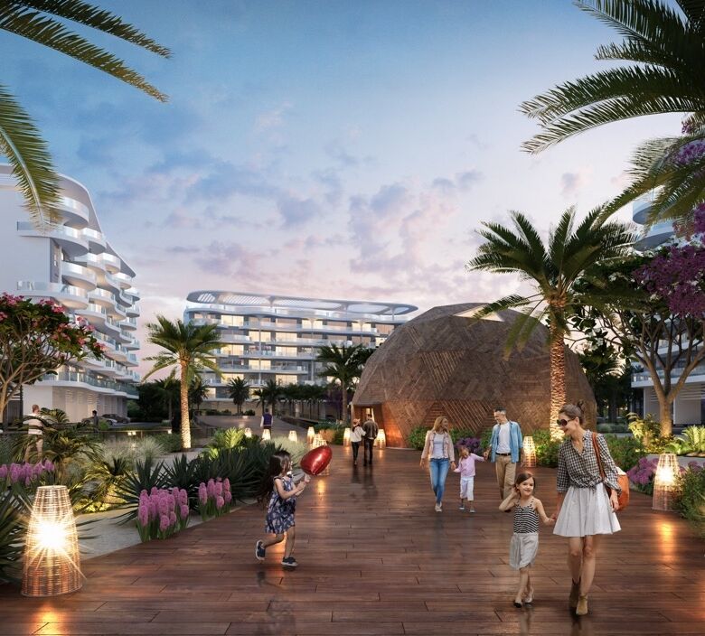 Modern waterfront apartments in Dubai with lush gardens and lagoon views.