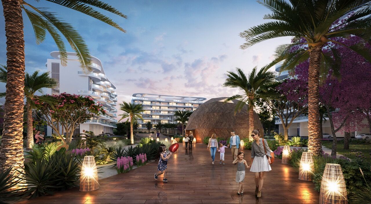 Modern waterfront apartments in Dubai with lush gardens and lagoon views.