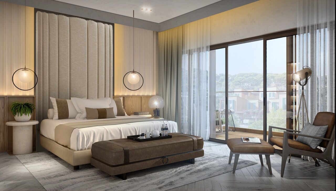 Luxury bedroom with large windows overlooking scenic views of Greek island-inspired Dubai community.