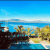 Beautiful view of Subic Bay with palm trees and a pool in the foreground.