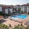 Pool view apartment in Ravda with spacious outdoor area and sun loungers.