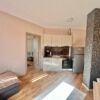 Modern 1-bedroom top floor apartment near the coast with bright living space.