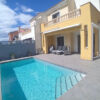 Beautiful outdoor pool area with sun loungers and seating.