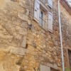 Stone village house with courtyard and terrace, featuring traditional stone walls and wooden shutter.