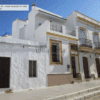 Facade of a white painted chalet in Ayamonte, Spain, on a sunny day.