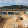 Cozy flat terrace overlooking the Etang with small residence and swimming pool.