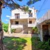 Village house with garden, garage, and outdoor space in a peaceful setting.