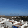 Panoramic view of Ayamonte with white buildings and blue sky.