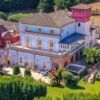 Villa with sea view in Silvi, Abruzzo, featuring colorful architecture and lush gardens.