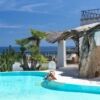 Seaside villa in San Teodoro featuring a private pool, outdoor dining area, and stunning ocean views.