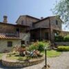Villa for sale in Città della Pieve with beautiful garden and traditional stone architecture.