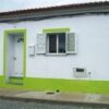 House with white walls and green accents, located in Salvada.