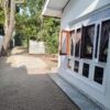 House exterior with large windows and garden view in Colombo.