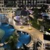 Night view of a luxury hotel pool with lighting and surrounding greenery in Boracay.