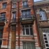 Spacious renovation project townhouse with classic brick facade in Brussels, featuring balconies and.