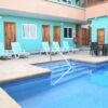 Beachfront hotel pool with sun loungers and outdoor dining area for guests in Manabi.
