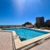 Rooftop swimming pool with cityscape views in El Campello, Alicante.