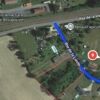 Aerial view of a plot of land for sale in Tauzinade, Dordogne, with surrounding homes and greenery.