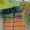 Beautiful wooden gate at the entrance of a luxurious Costa Rican property.