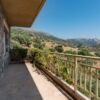 Beautiful stone villa balcony overlooking lush hills and mountains in Neapolis Lakonia.
