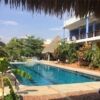 Pool view at Sunset Point Estate, Puerto Escondido, Oaxaca, with lush tropical surroundings.