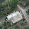 Aerial view of a 3-bedroom house with land for sale in Sant Andrea Bonagia, surrounded by greenery a.