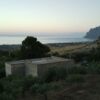 Land with house for sale in Sant Andrea Bonagia with sea views and mountain backdrop.