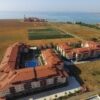 Aerial view of a 1-bedroom apartment complex near the sea in Chateau Aheloy 2.
