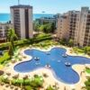 Pool with city views and surrounding sun loungers at a 5-star resort.