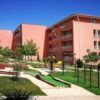 Modern pink apartment buildings with green gardens and playground in Sunny Day 6, Sunny Beach.
