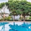 Pool at Emerald Beach Resort, Ravda, with lush greenery and shaded seating areas.