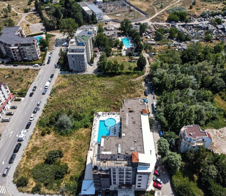 Aerial view of new apartments in Sunny Beach, 600m from the sea, with pools and green spaces.