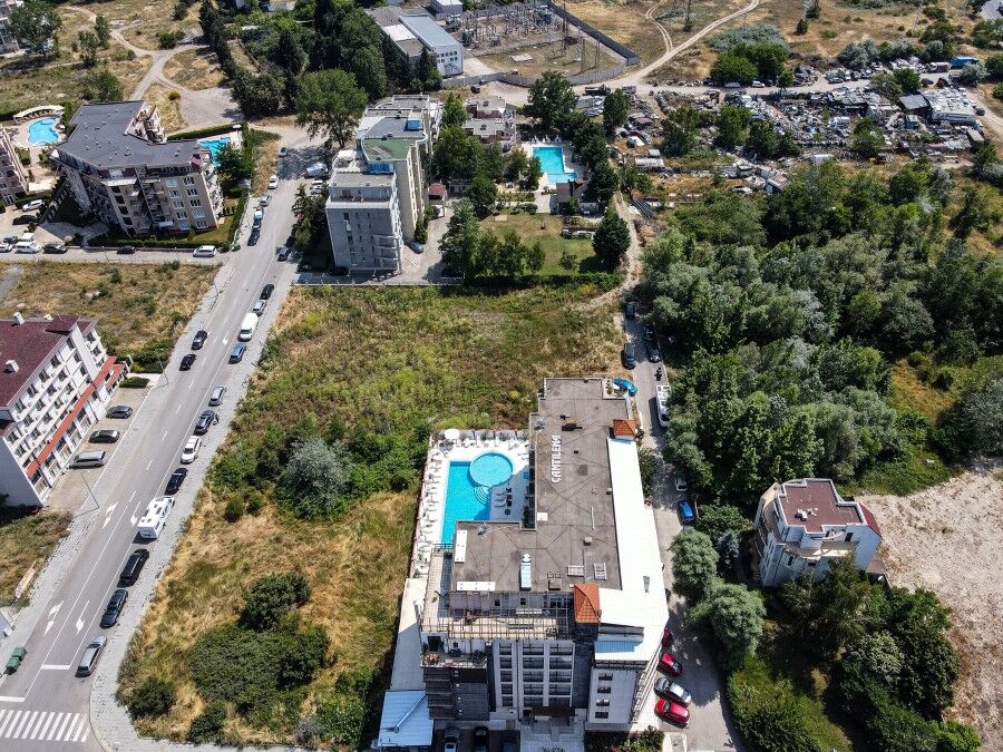 Aerial view of new apartments in Sunny Beach, 600m from the sea, with pools and green spaces.